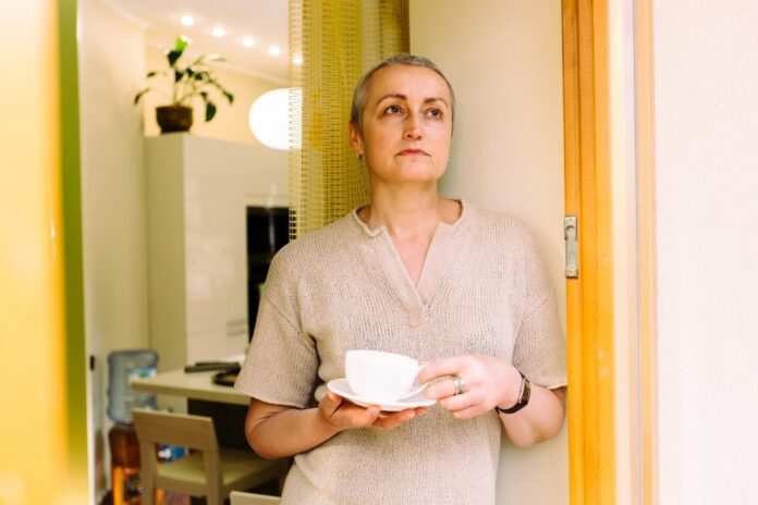 Unimpressed middle aged woman with cuppa shutterstock