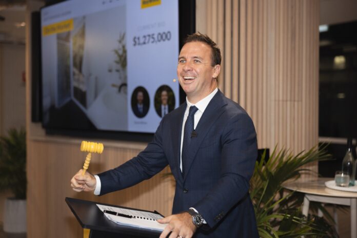 Auctioneer Dan Sowden with auction hammer in hand.