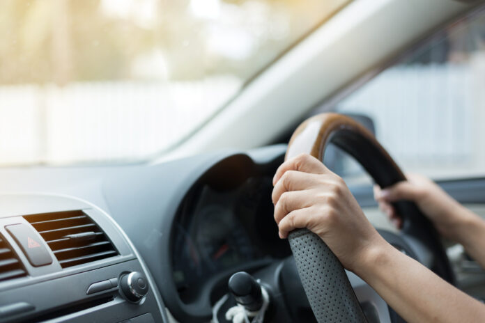 Hands on a steering wheel.