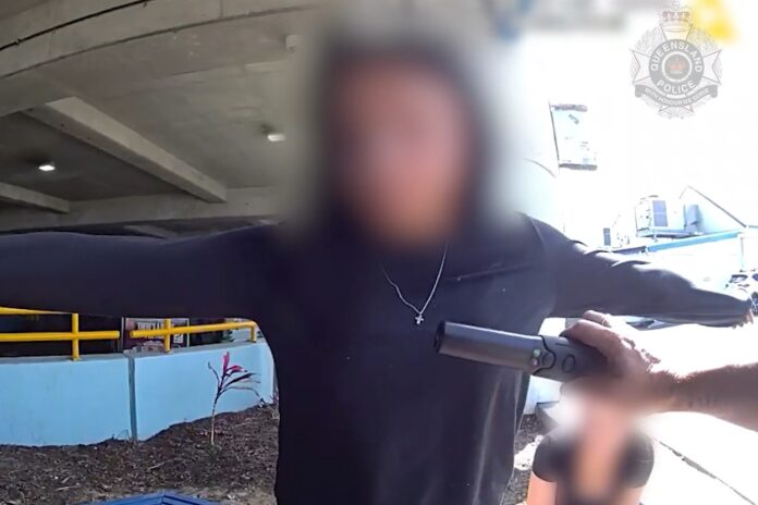 Police scan a youth at Caloundra.
