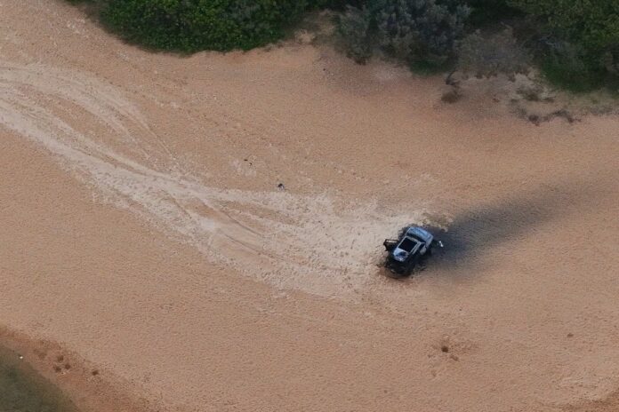 An aerial photo of the burnt remains of a vehicle at Moffat Beach. Picture: Damien Lange, droner.au.