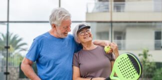 elderly couple playing tennis Shutterstock