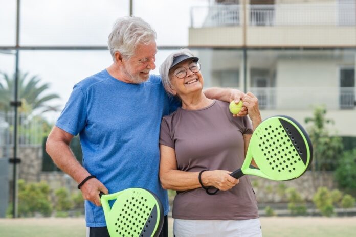 elderly couple playing tennis Shutterstock