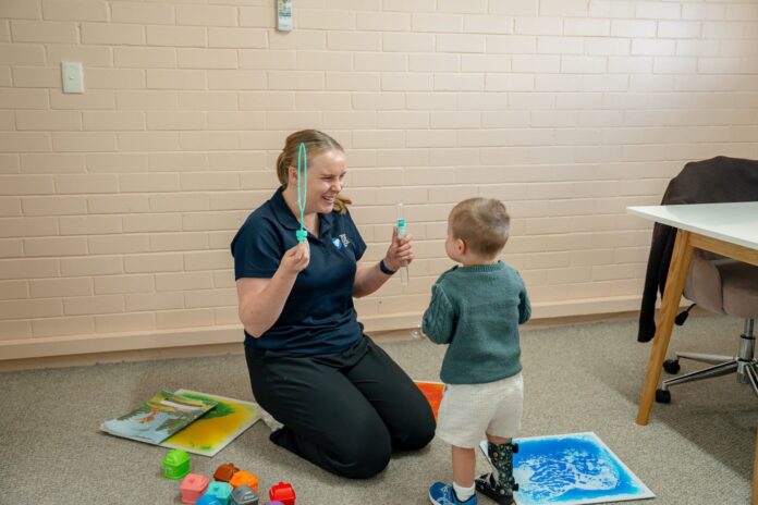 Speech pathologist working with a young child