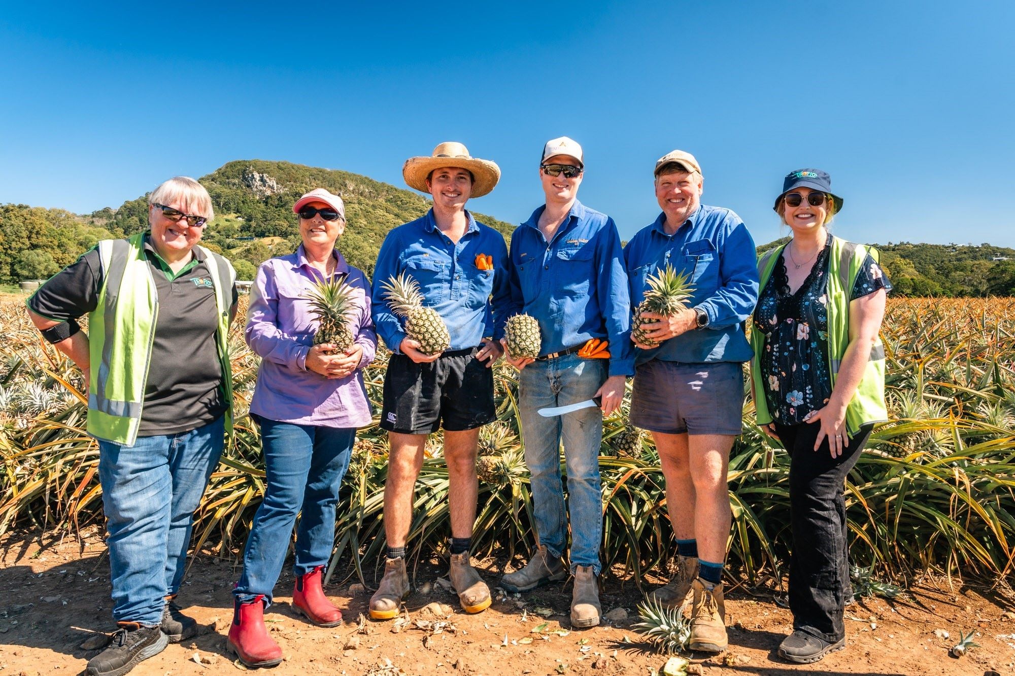 Tropico's Judith Kerr and Aleisha Hubbucks with the team from Oakes local pineapple farm: Sarah, Will, James and Murray Oakes.