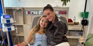 Michaela Grace (left) begins treatment in hospital with the support of her friend.