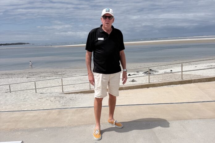man standing on a seawall