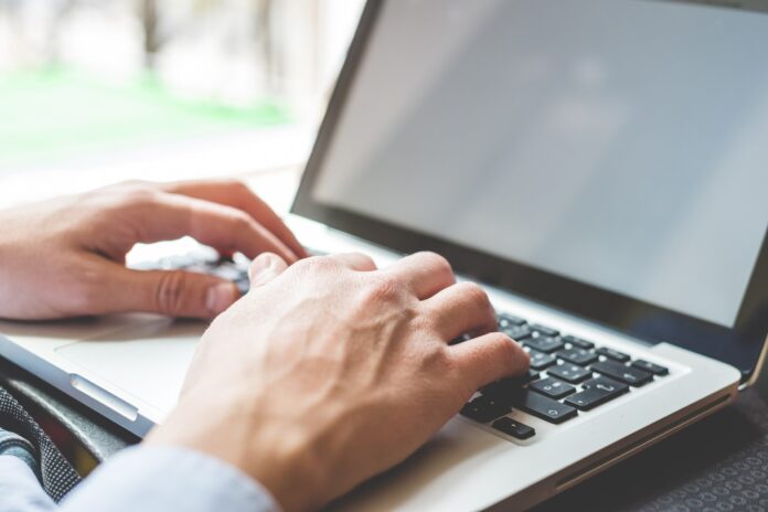 Hands at a laptop.