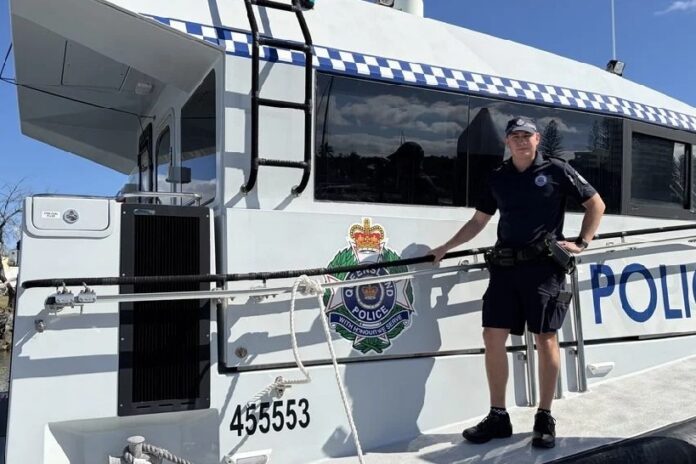 Constable Adam Threlfall on a police boat.