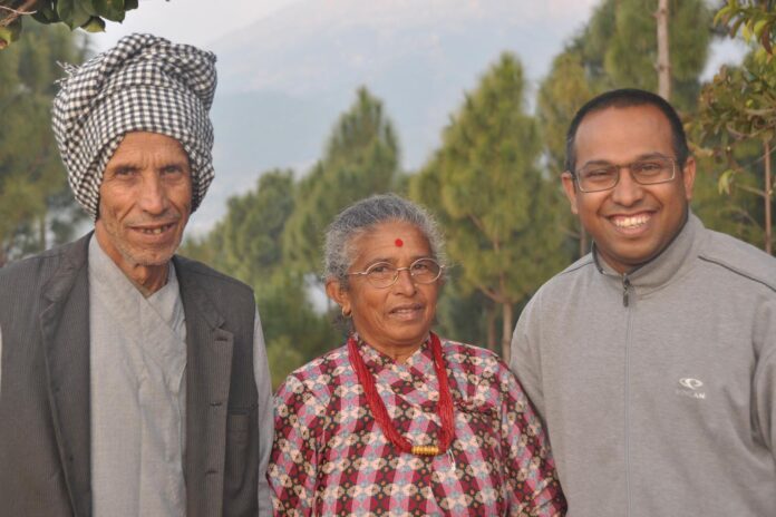 Dr Ratna Paudyal and his parents at his home village in Nepal. Picture: UniSC