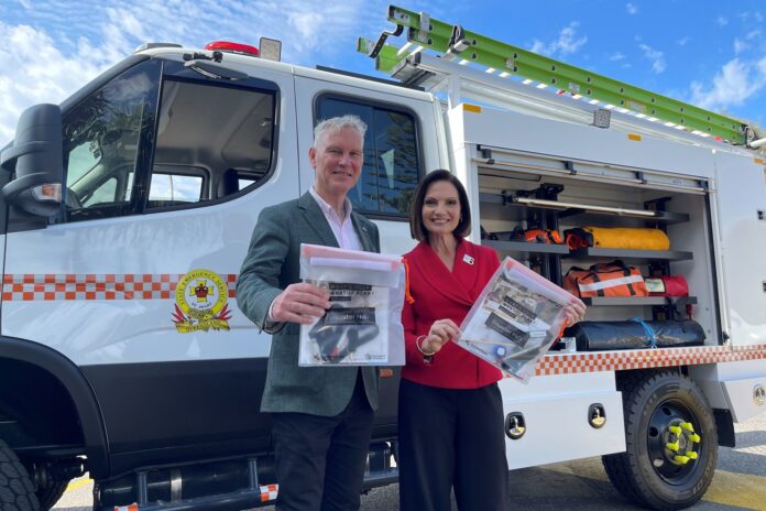 Sunshine Coast mayor Rosanna Natoli and Noosa mayor Frank Wilkie with Get Ready packs, in front of a fire truck.