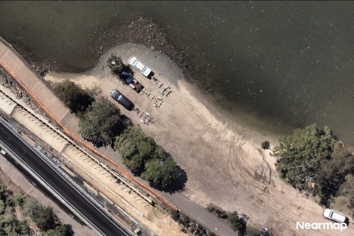 An aerial photo of the The Doonella Boat Ramp shows a dirt road and three vehicles with trailers. Picture: Nearmap.