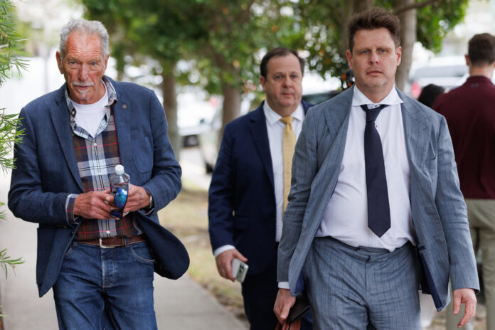 The father of Sam Wood, Andrew Wood (left), barrister David Cole (back right) and lawyer Mathew Cuskelly (front right) are seen approaching Maroochydore Magistrates Court on Thursday. Picture: AAP Image/Russell Freeman.