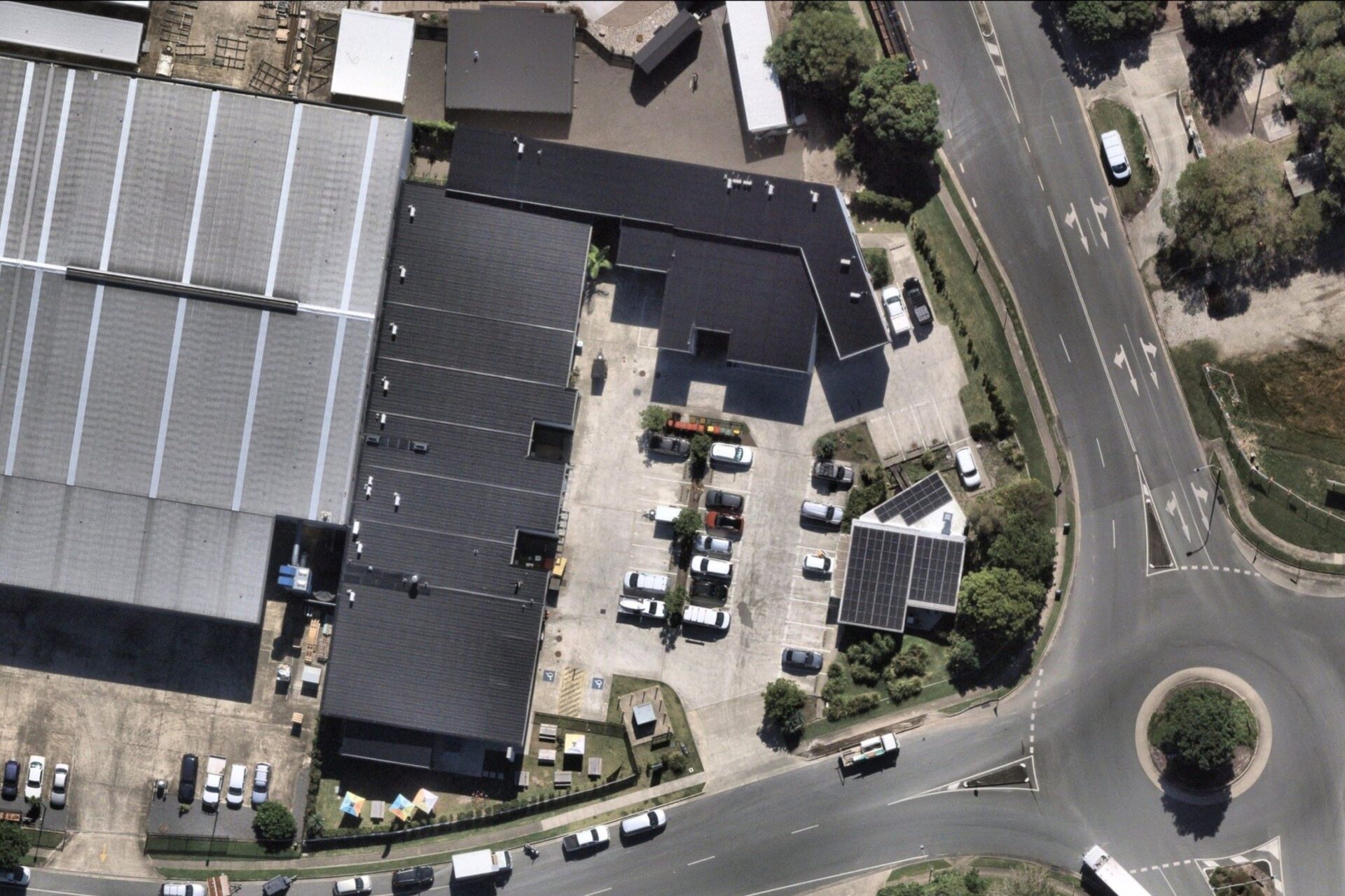 An aerial shot of a road, car park and the industrial complex at 2 Junction Drive, Coolum.