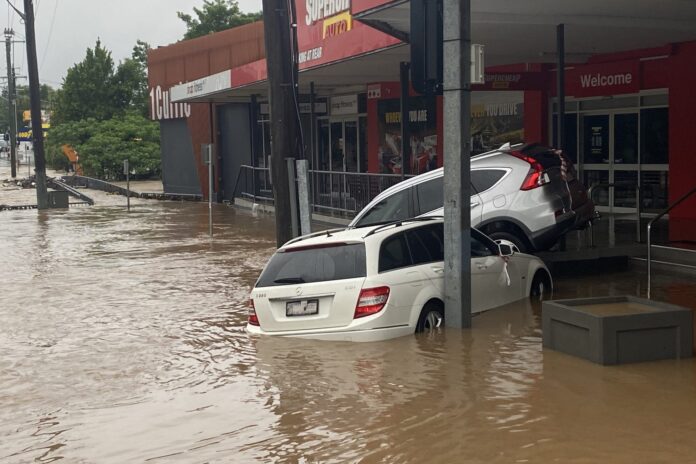 Two cars caught in floodwaters on Currie Street in Nambour.