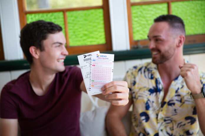 Two men smile and hold out Keno tickets.