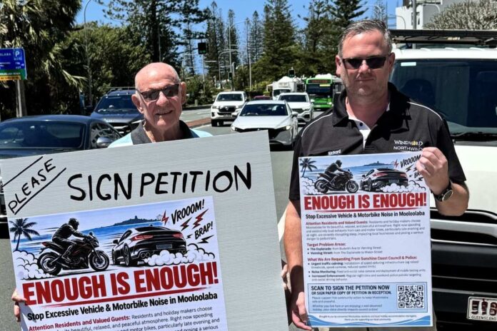 Property owner and long-time resident Terry Howard and Windward Apartments manager and long-time resident Richard Waterson beside Mooloolaba Esplanade with a sign saying 'enough is enough'.