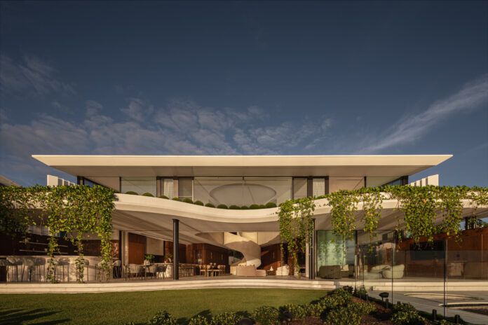 An architecturally designed house with a sprawling entertainment area and greenery