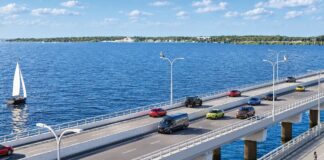 An artist's impression of the bridge between Sandstone Point and Bribie Island shows cars on a four-lane bridge alongside a pedestrian bridge.