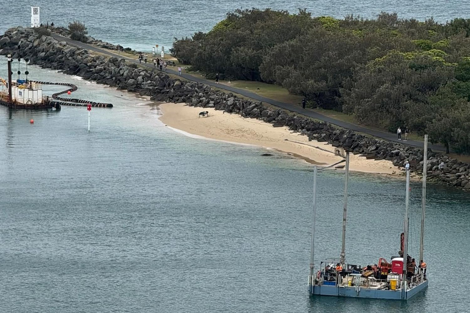 The Shine Barge, bottom right, in the Mooloolah River before it encountered difficulties. A regular dredger is pictured top left.