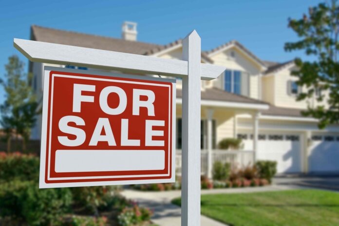 For Sale sign outside a home - shutterstock