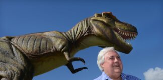 Clive Palmer with one of the more than 160 life-sized dinosaurs he brought to Coolum.